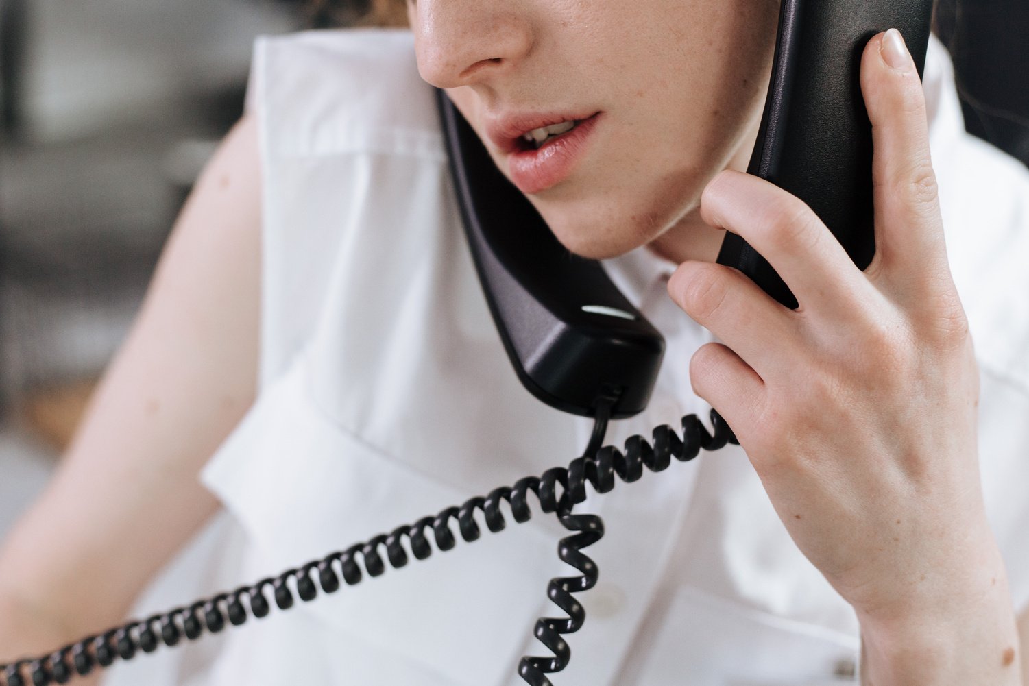 Woman Talking on Telephones